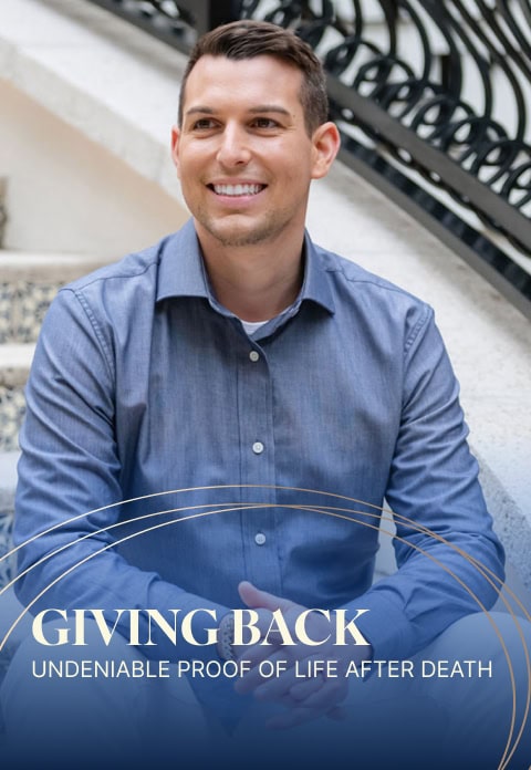 Man sitting on stairs, smiling, with text overlay reading: "Giving Back: Undeniable Proof of Life After Death - Matt Fraser.